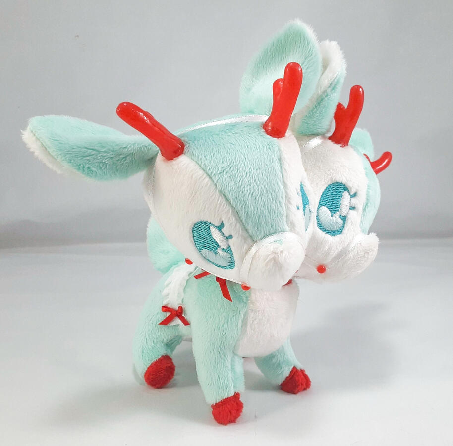 Doppel Reindeer (2020) A mint green two-headed reindeer plush with red accents