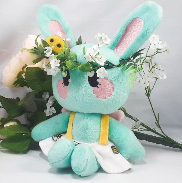 Spring Lolly A mint green rabbit plush with a flower crown